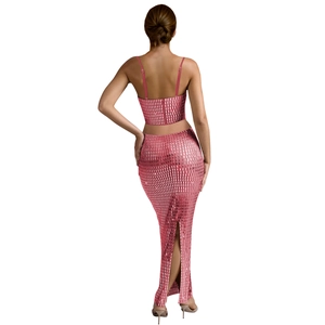 Detail of pink sequin two-piece dress showing back slit and shimmering mesh texture