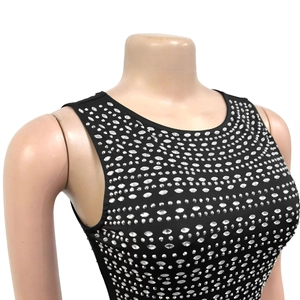 Close-up of sparkling silver rhinestones on a slim fit black sleeveless dress