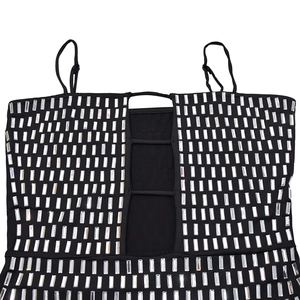 Close-up of black dress with silver rhinestone stripes and cutout strap details