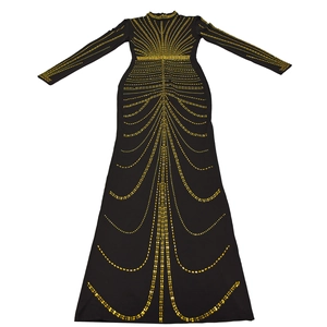 Detail of a black long sleeve evening gown featuring intricate golden rhinestone patterns