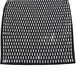 Close-up of black fabric with silver rectangular rhinestones in a matrix pattern