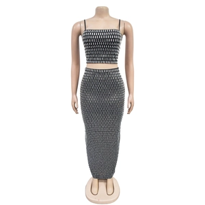 Detail of shimmering silver rhinestones on a black two-piece sleeveless maxi dress