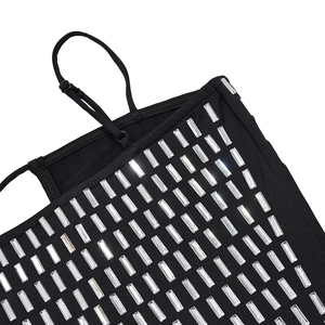 Detailed macro view of black dress featuring sparkling rhinestones and adjustable straps