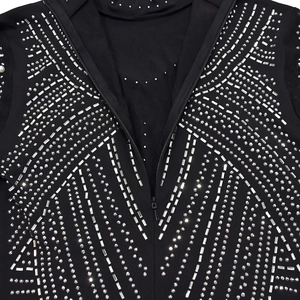 Detail of a black bodycon dress featuring silver rhinestone geometric patterns and a zipper