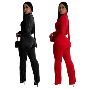 Detail of sequin jumpsuit with high neck and matching scarf in black and red colors