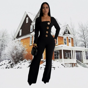 Detail of elegant black long sleeve jumpsuit with square neck and gold embossed buttons