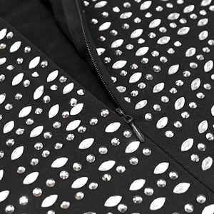 Detail of silver rhinestones and invisible zipper on black bodycon dress fabric