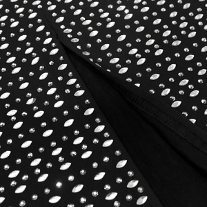 Macro detail of black dress fabric featuring marquise rhinestones and slit design