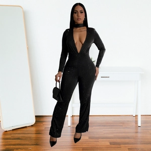 Detail of black V-neck long sleeve jumpsuit with shimmering rhinestone embellishments