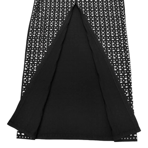 Detailed close-up of a black high-slit dress featuring a dense silver rhinestone pattern