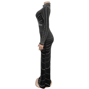 Detail of black long sleeve bodycon dress with intricate vertical rhinestone patterns