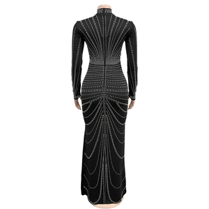 Detail view of rhinestone geometric patterns and back zipper on black long sleeve dress