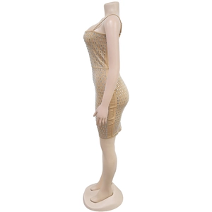 Detail of champagne gold mini dress featuring shimmering silver rectangular sequins on fabric