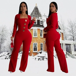 Detail of red square neck jumpsuit with long sleeves and large gold decorative buttons