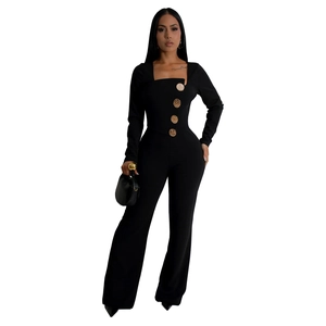 Detail of elegant black long sleeve jumpsuit featuring decorative gold embossed buttons