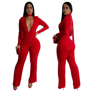 Deep V-neck red jumpsuit with long sleeves and sparkling rhinestone embellishments