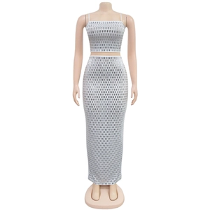 Detail of white sequin grid pattern on high waist crop top and slim fit maxi skirt