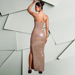 Detail of champagne gold sequin dress featuring side slit and shimmering mesh texture