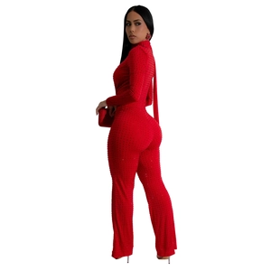 Detail view of sparkling red rhinestones on sexy long sleeve V-neck fashion jumpsuit