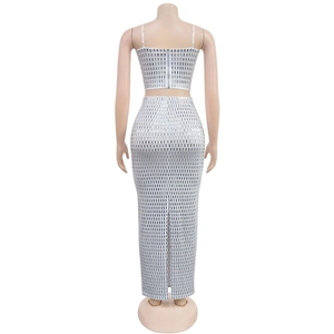 Detail of silver sequin two-piece set featuring back zipper and slit floor-length skirt