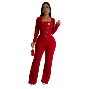 Detail of square neck red jumpsuit featuring four decorative large golden buttons