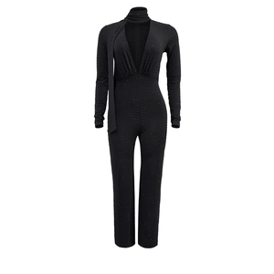 Detail of black long sleeve jumpsuit with V-neck, neck accessory and sparkling rhinestones