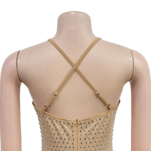 Détail d'une robe beige ajustée avec strass argentés et fines bretelles croisées