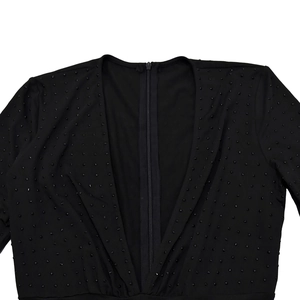 Detailed close-up of V-neckline with black rhinestones and hidden zipper on bodysuit