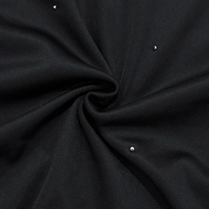 Détail macro du tissu en maille noire avec perles argentées et texture haute densité