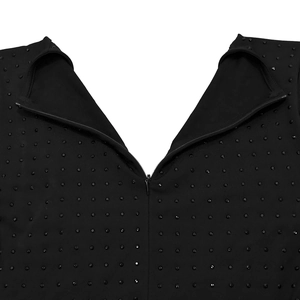 Close-up of black V-neck jumpsuit featuring sparkling rhinestones and hidden back zipper