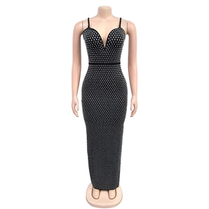 Close-up of sparkling silver rhinestones on a slim fit sexy black split evening dress