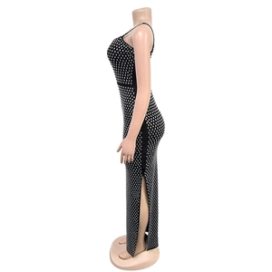Detail of a black bodycon dress with silver rhinestones and a side slit on a mannequin