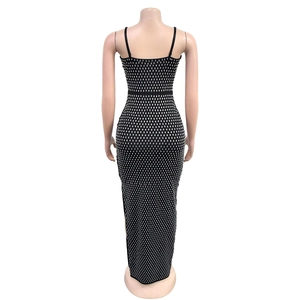 Detailed back view of a slim black dress featuring sparkling silver rhinestones and a slit