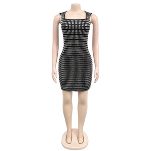 Detail of square neck black mini dress featuring shimmering silver rectangular sequins
