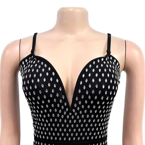 Macro detail of sexy deep V-neck black dress with sparkling silver rhinestones