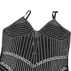 Détail d'une robe moulante noire avec motifs en strass argentés et décolleté en V en maille