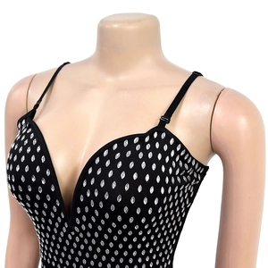 Detail of a slim-fit black dress featuring silver rhinestones and adjustable spaghetti straps