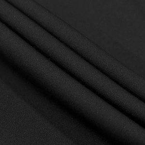 Detail of premium black knitted fabric with diagonal texture and matte finish of jumpsuit