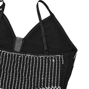 Détail d'une robe noire à col en V avec des lignes de strass argentés étincelants