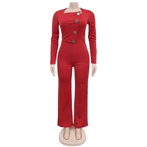 Detail of red long sleeve jumpsuit with asymmetric neck and vintage gold buttons