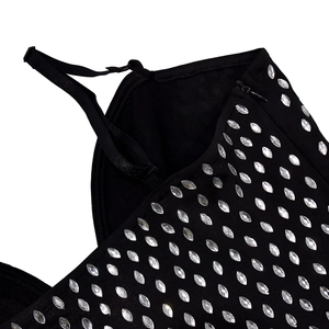 Detailed close-up of rhinestone embellishments and adjustable strap on a black dress