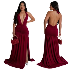 Detail of burgundy halter neck dress featuring deep V-neckline and high slit skirt