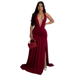 Detail of the side slit and ruched waist on a sexy burgundy deep V-neck halter maxi dress