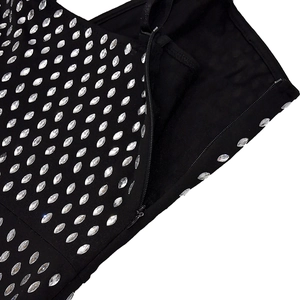 Detailed close-up of a black party dress with silver rhinestones and a side zipper