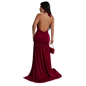 Back view of wine red halter evening dress featuring open back and ruched detail