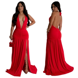 Detail view of red halter neck dress featuring deep V-neckline and side high slit