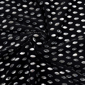 Close-up of high-density silver navette rhinestones on black stretch fabric detail