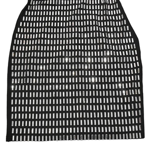 Detailed view of shimmering silver rhinestones on a slim black bodycon dress fabric