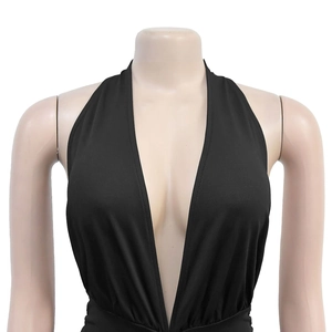 Detail shot of the deep V-neckline and halter neck design on this black dress