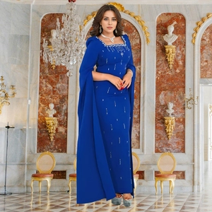 Detail of royal blue dress featuring cape sleeves and intricate rhinestone embellishments